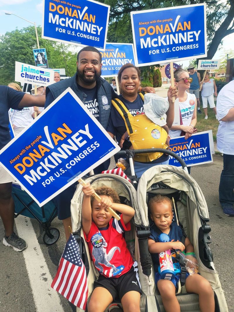 Donavan McKinney with his family at a campaign parade, surrounded by “Donavan McKinney for U.S. Congress” signs